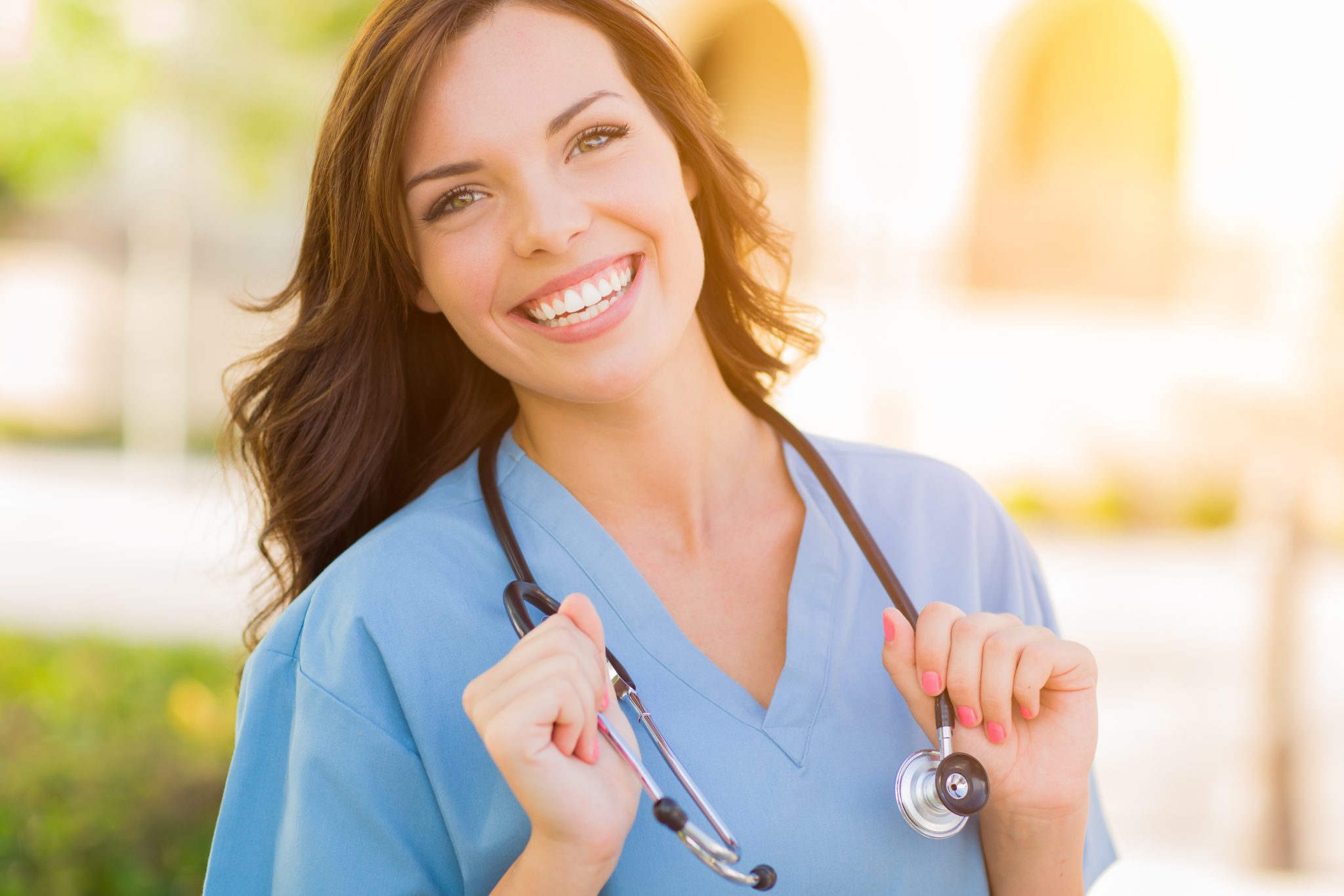 Medical assistant smiling with stethoscope around her neck