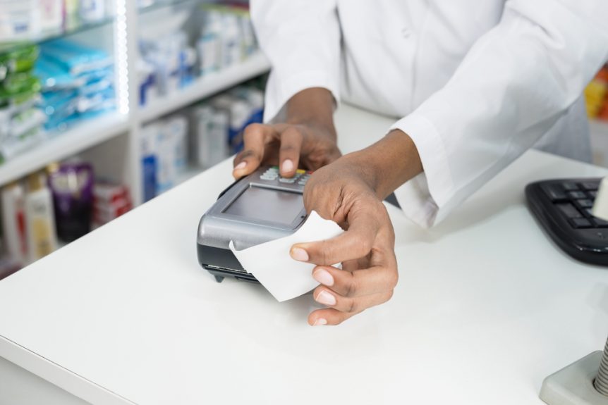 Pharmacist holding a receipt coming out of a portable printer