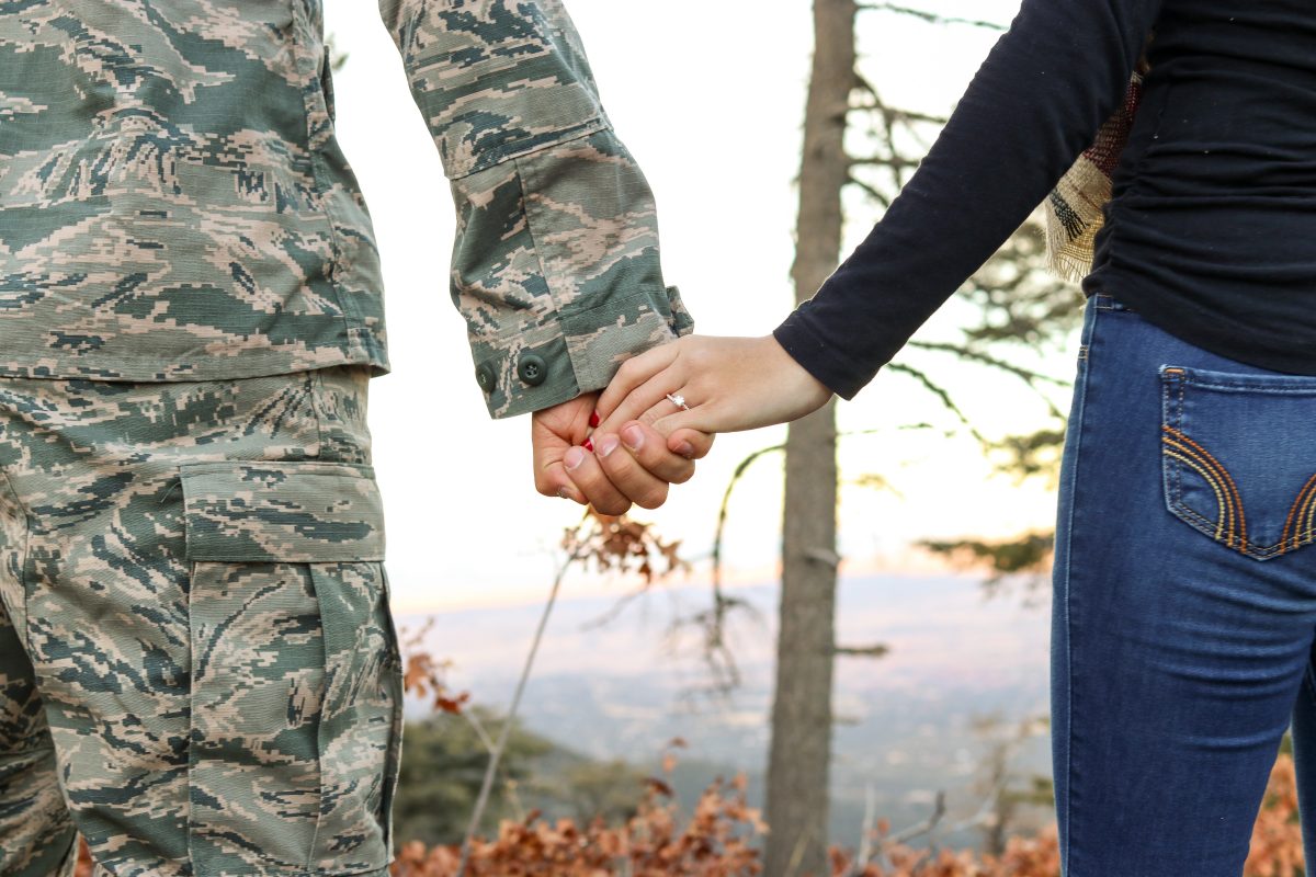 Military Spouse Holding Hands with Soldier